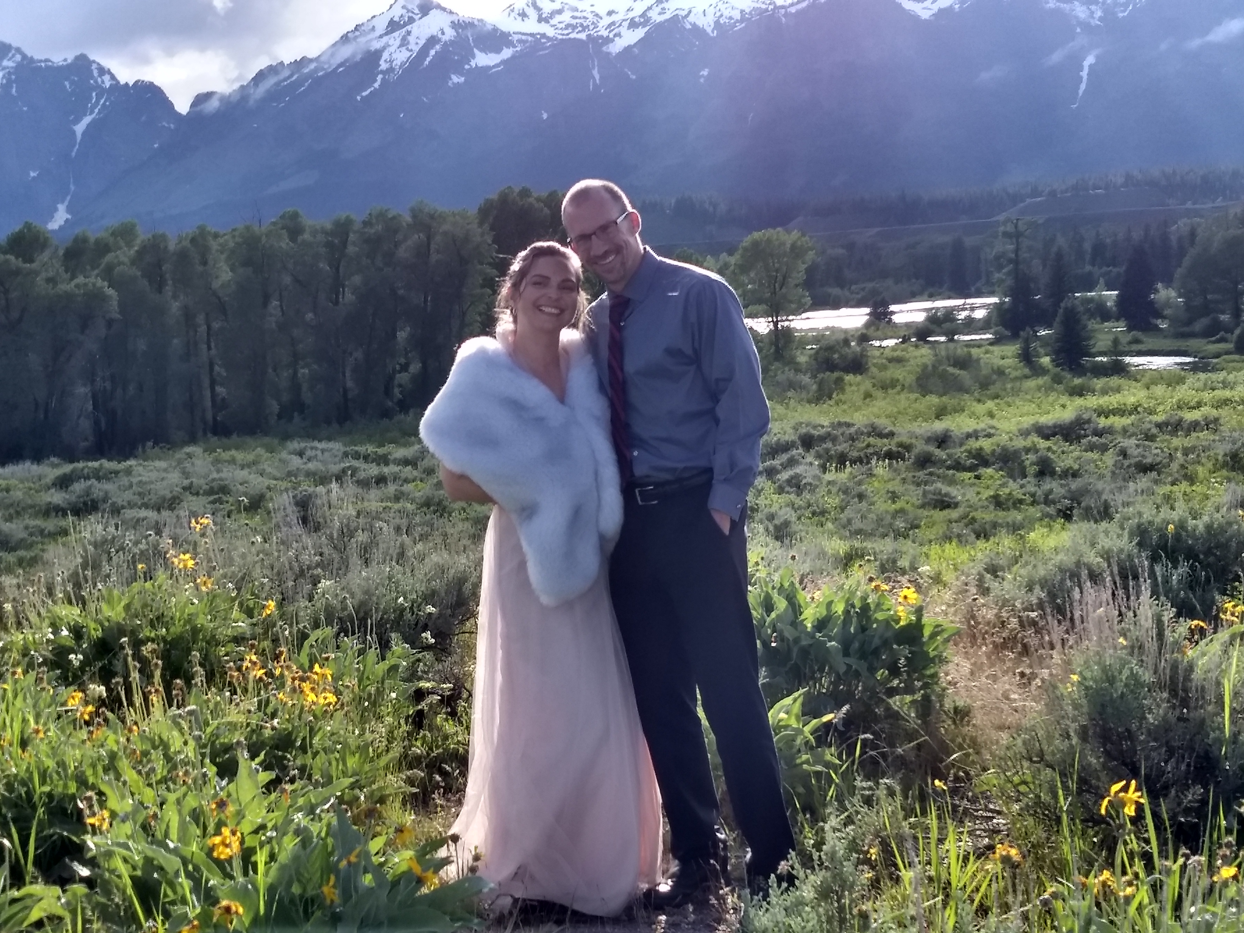 Dave and Krista looking very couple-y at the wedding in Wyoming where they met, with the Tetons in the background.